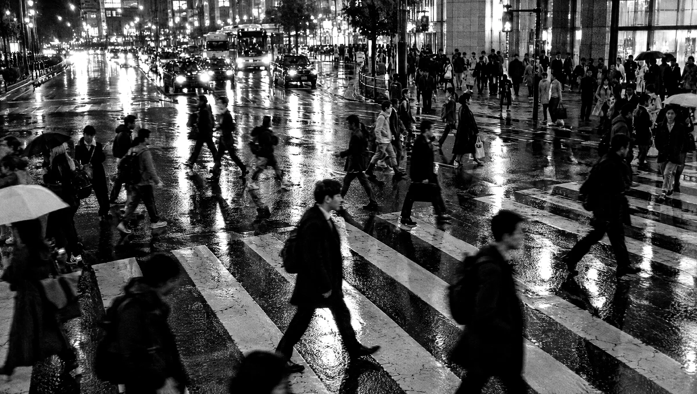 Crowd crossing a city street at night